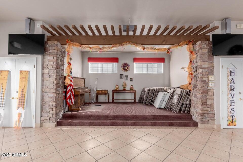 2121 North Center Street, Unit 120 Mesa, AZ 85201 - Photo 28 of 34 a living room with furniture a flat screen tv and a fireplace