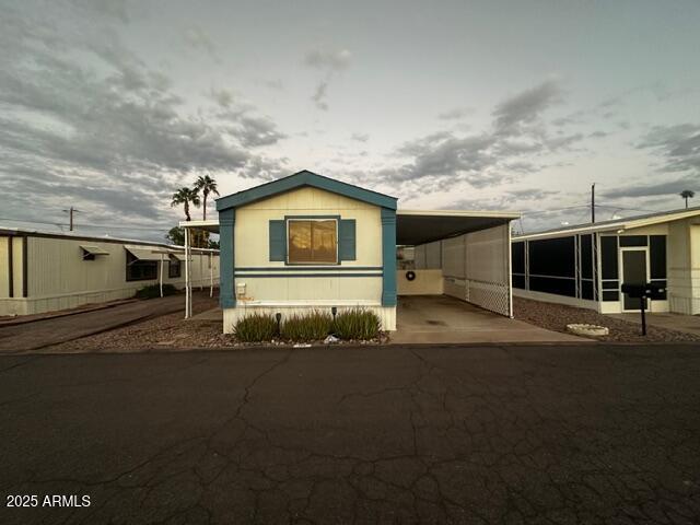 2121 North Center Street, Unit 120 Mesa, AZ 85201 - Photo 5 of 34 a front view of a house with a garage