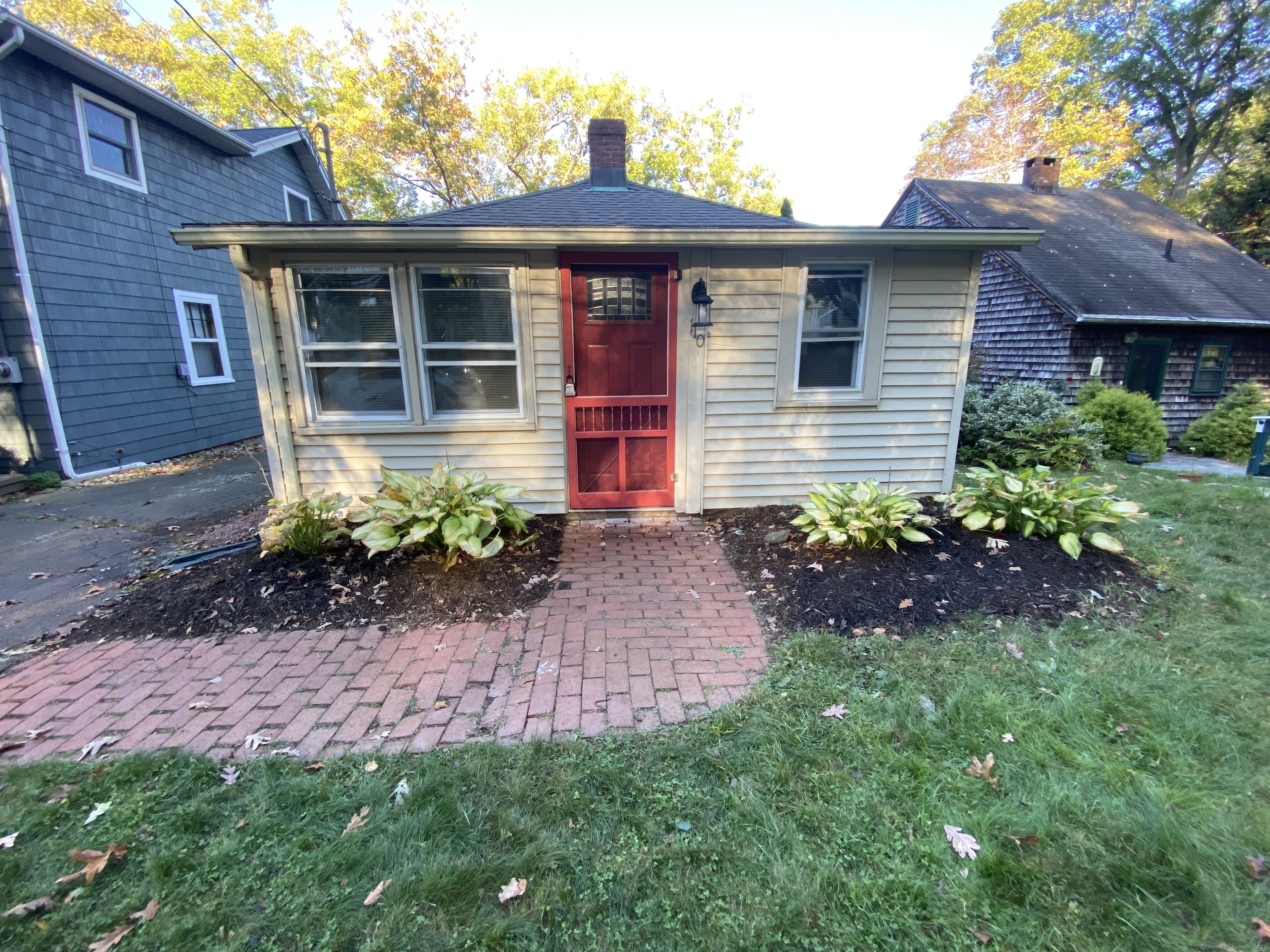 a front view of a house with a yard and outdoor seating