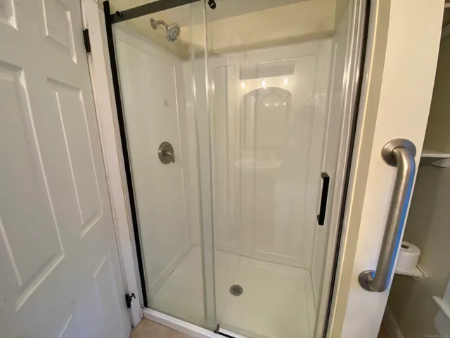 a bathroom with a glass door shower and sink