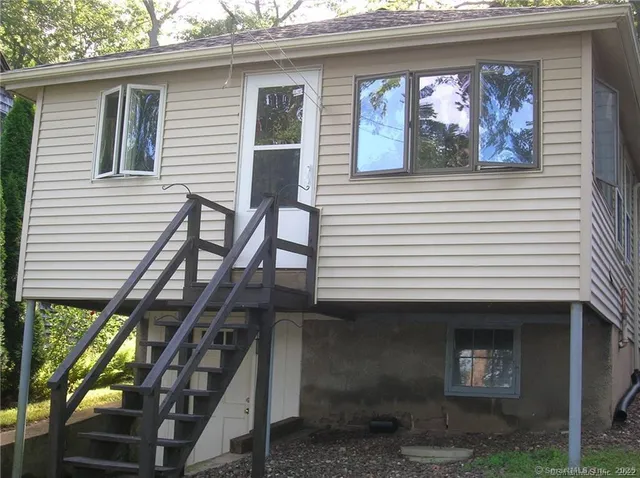a view of dirt yard with a large tree