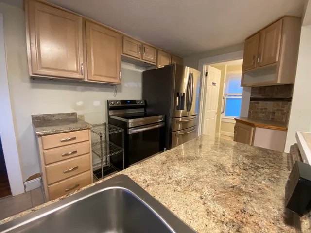 a kitchen with a refrigerator stove and cabinets