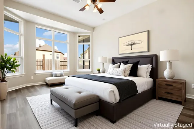 a bedroom with a bed and a large window