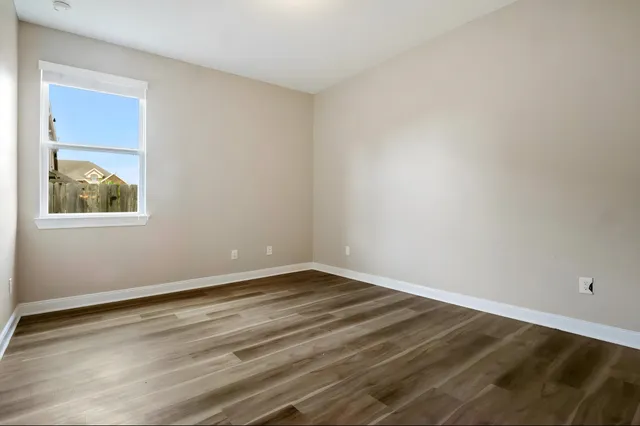 a bathroom with a granite countertop bathtub shower sink vanity and toilet