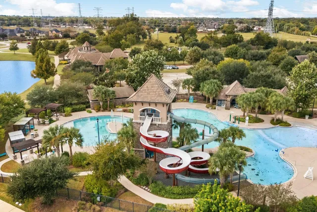 a view of a swimming pool with furniture