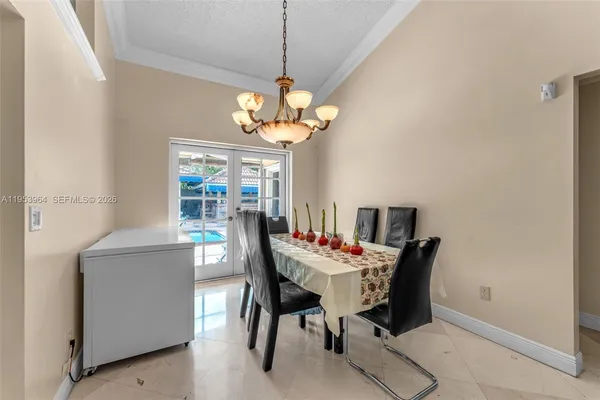a view of a dining room with furniture and a chandelier