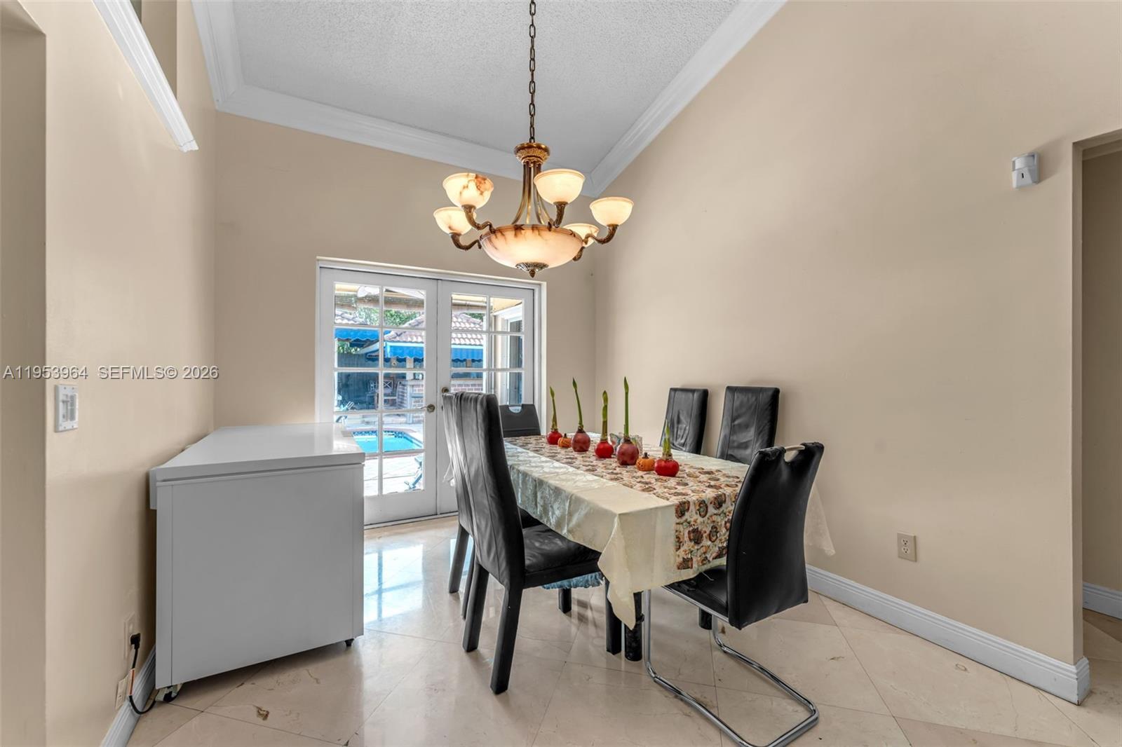 14920 Southwest 151st Terrace Miami, FL 33196 - Photo 15 of 27 a view of a dining room with furniture and a chandelier