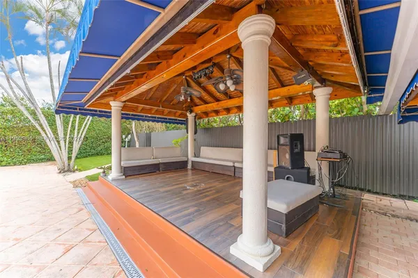 a view of a patio with table and chairs a barbeque with wooden floor and fence