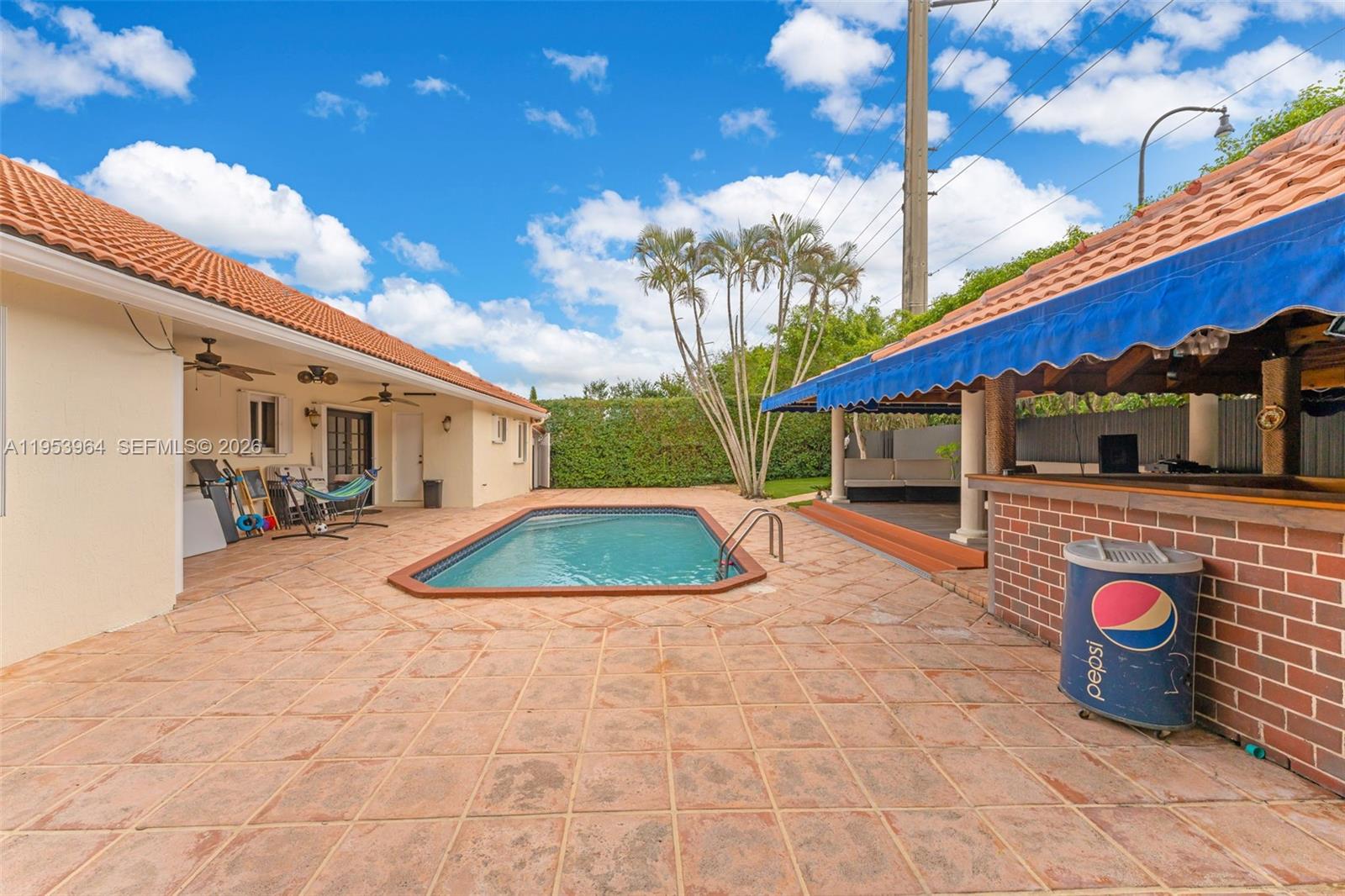 14920 Southwest 151st Terrace Miami, FL 33196 - Photo 23 of 27 a view of a white house with a yard and potted plants