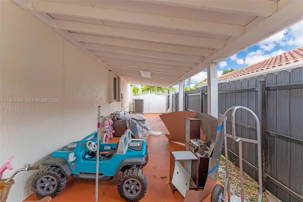 a view of a chairs and table in patio