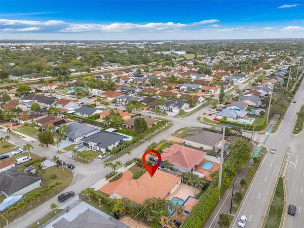 an aerial view of residential houses with outdoor space