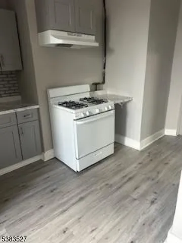 a view of a kitchen with wooden floor