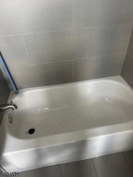104 President Street, Unit 8 Passaic, NJ 07055 - Photo 5 of 8 closeup view of a bathtub in bathroom