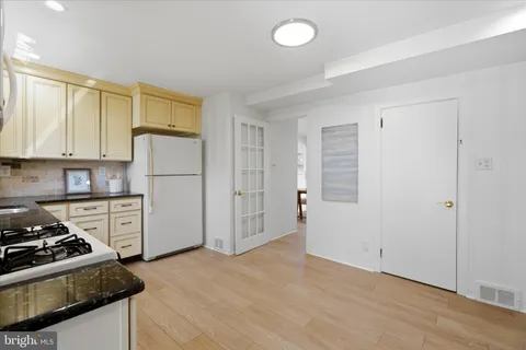 a kitchen with a stove a refrigerator and a sink