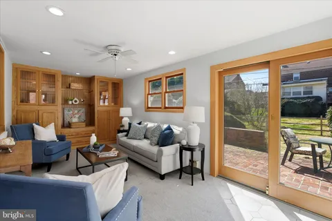 a living room with furniture and large windows