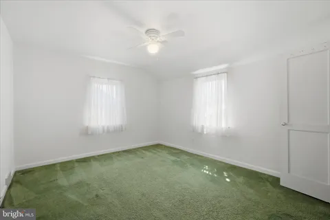 an empty room with a empty space and windows