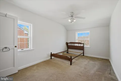 a living room with furniture and a ceiling fan