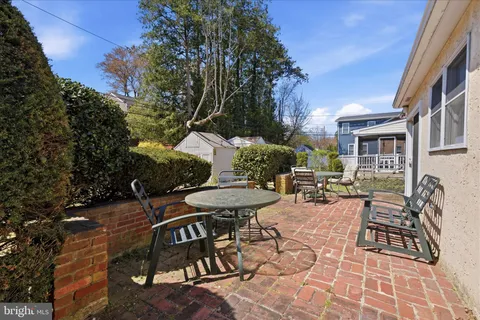 a view of a patio with table and chairs and potted plants