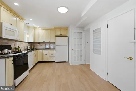 a kitchen with stainless steel appliances a refrigerator and a stove top oven
