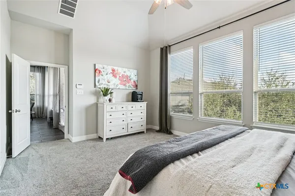 a bedroom with furniture and a flat screen tv