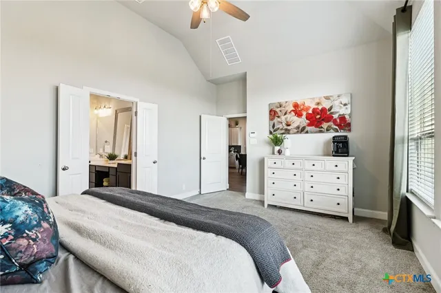 a spacious bedroom with a bed and a large window