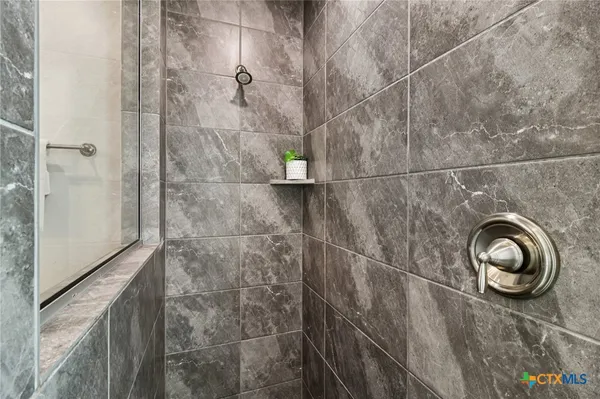 a bath tub sitting in a bathroom next to a window