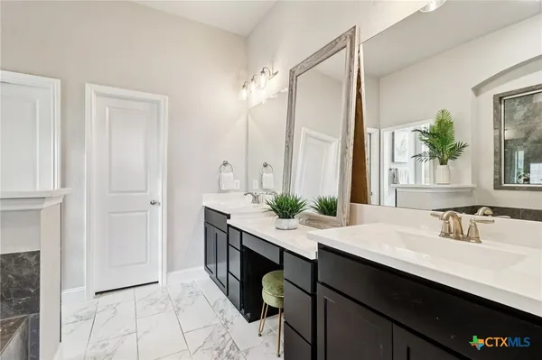 a bathroom with a sink toilet and mirror