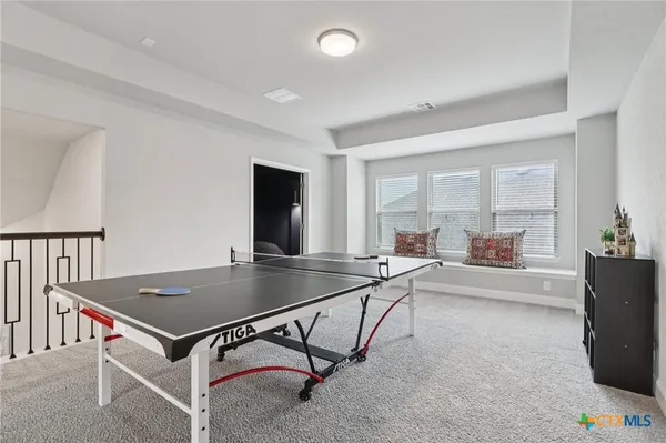 a room with furniture and air hockey table