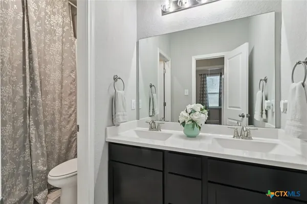 a bedroom with a bed and glass window