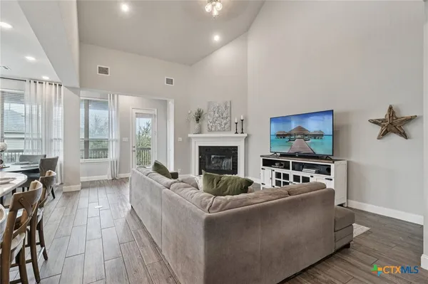 a living room with furniture fireplace and flat screen tv