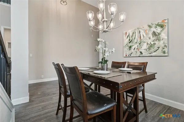 a view of a dining room with furniture and chandelier