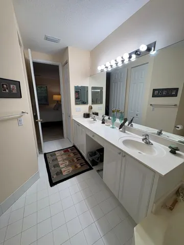 a bathroom with a double vanity sink a and mirror