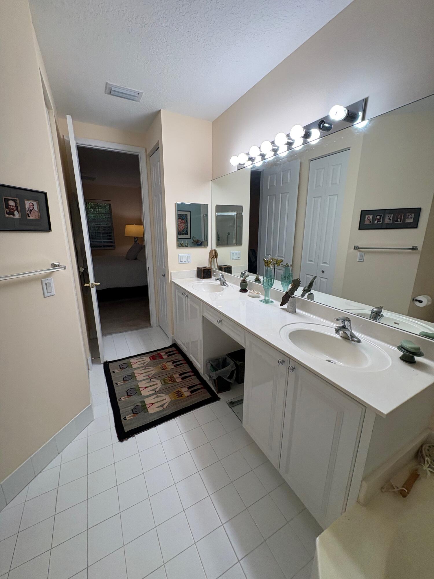 67 Legacy Court Delray Beach, FL 33445 - Photo 11 of 13 a bathroom with a double vanity sink a and mirror