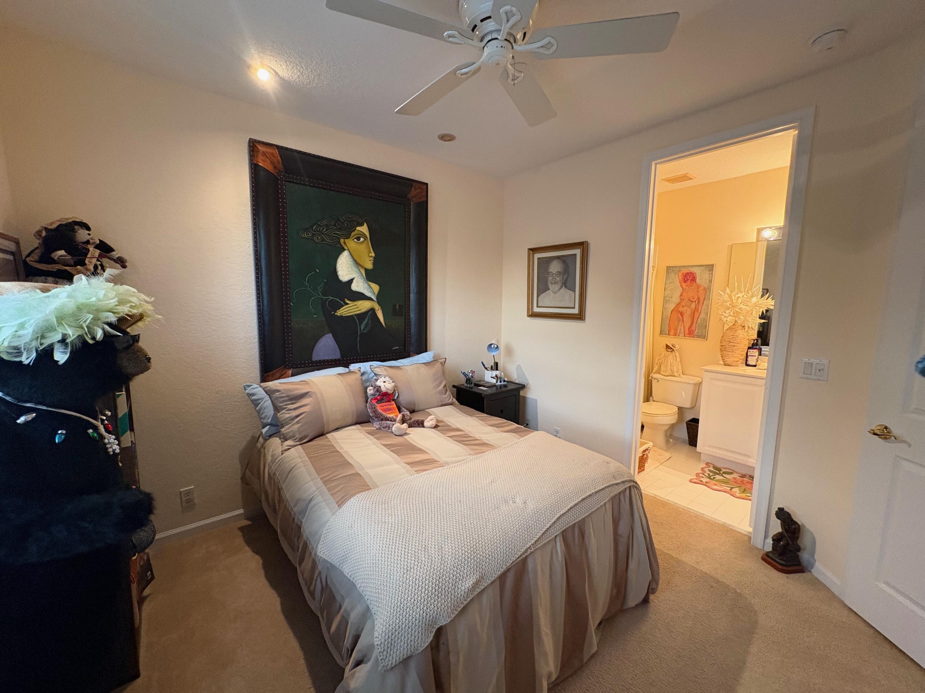 67 Legacy Court Delray Beach, FL 33445 - Photo 12 of 13 a bedroom with a bed and a chandelier