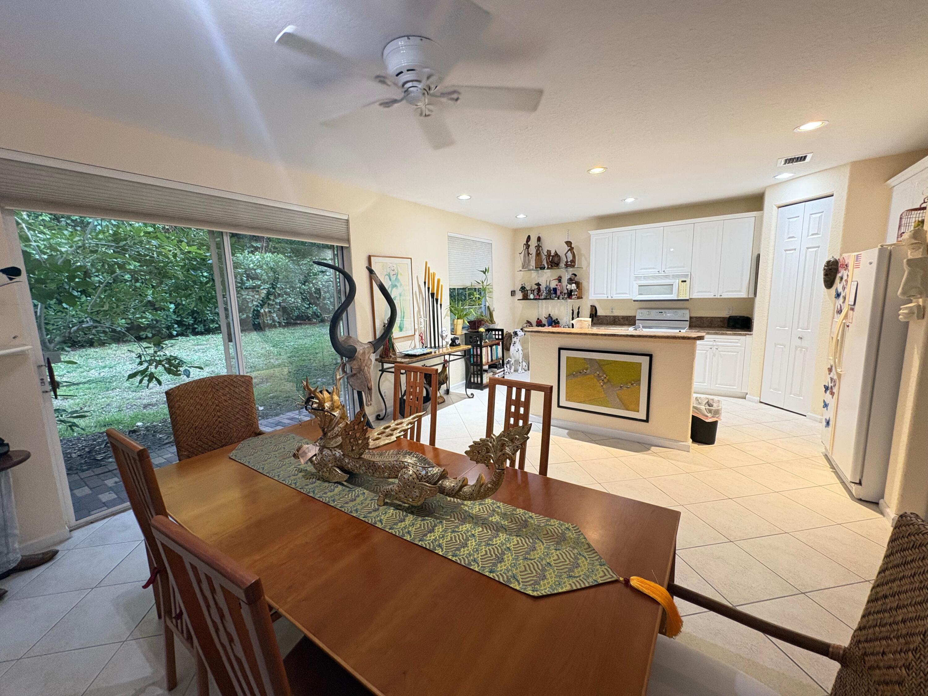 67 Legacy Court Delray Beach, FL 33445 - Photo 4 of 13 a view of a dining room with furniture a chandelier and wooden floor