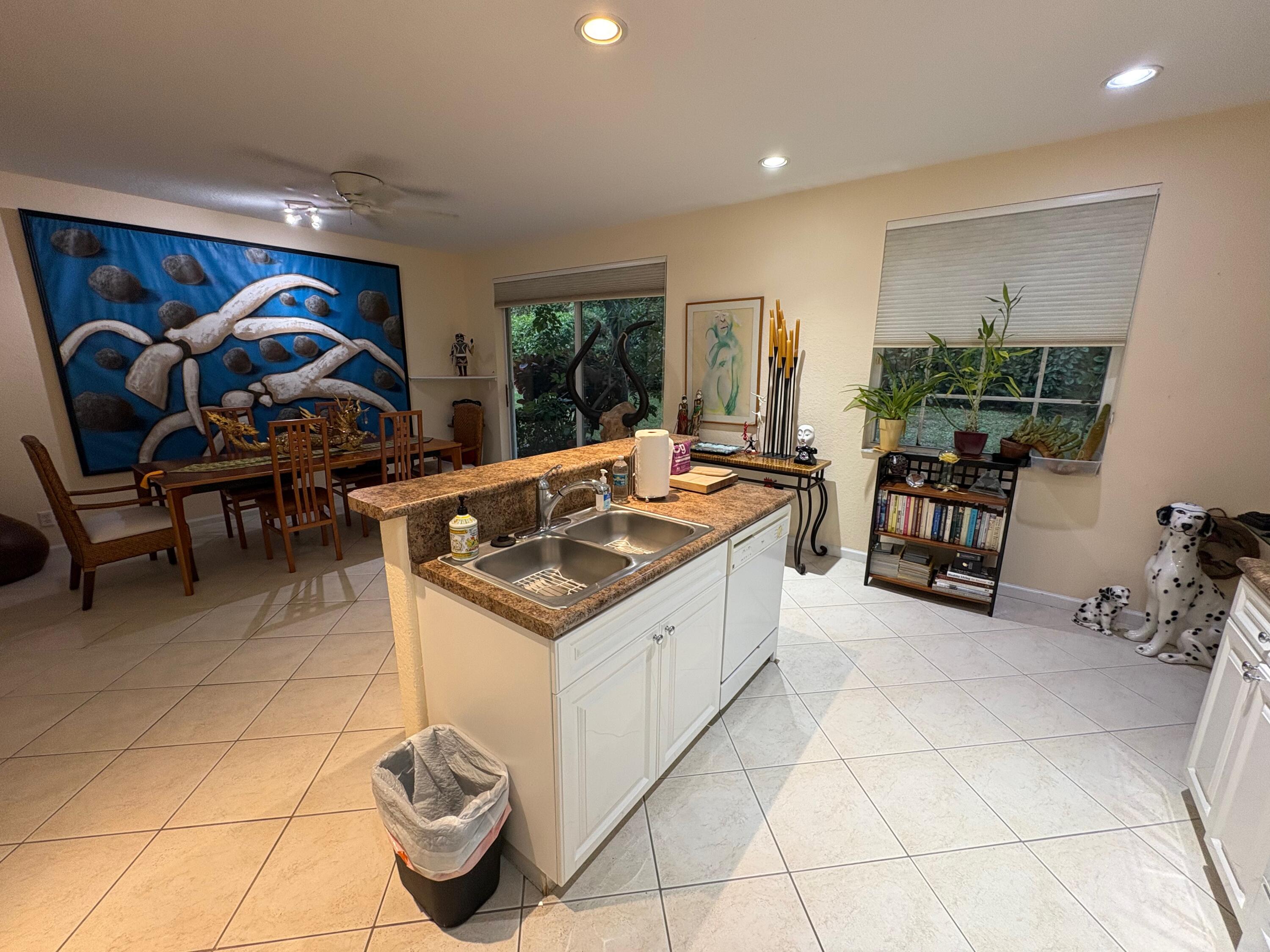 67 Legacy Court Delray Beach, FL 33445 - Photo 7 of 13 a kitchen that has a lot of cabinets a sink and a stove