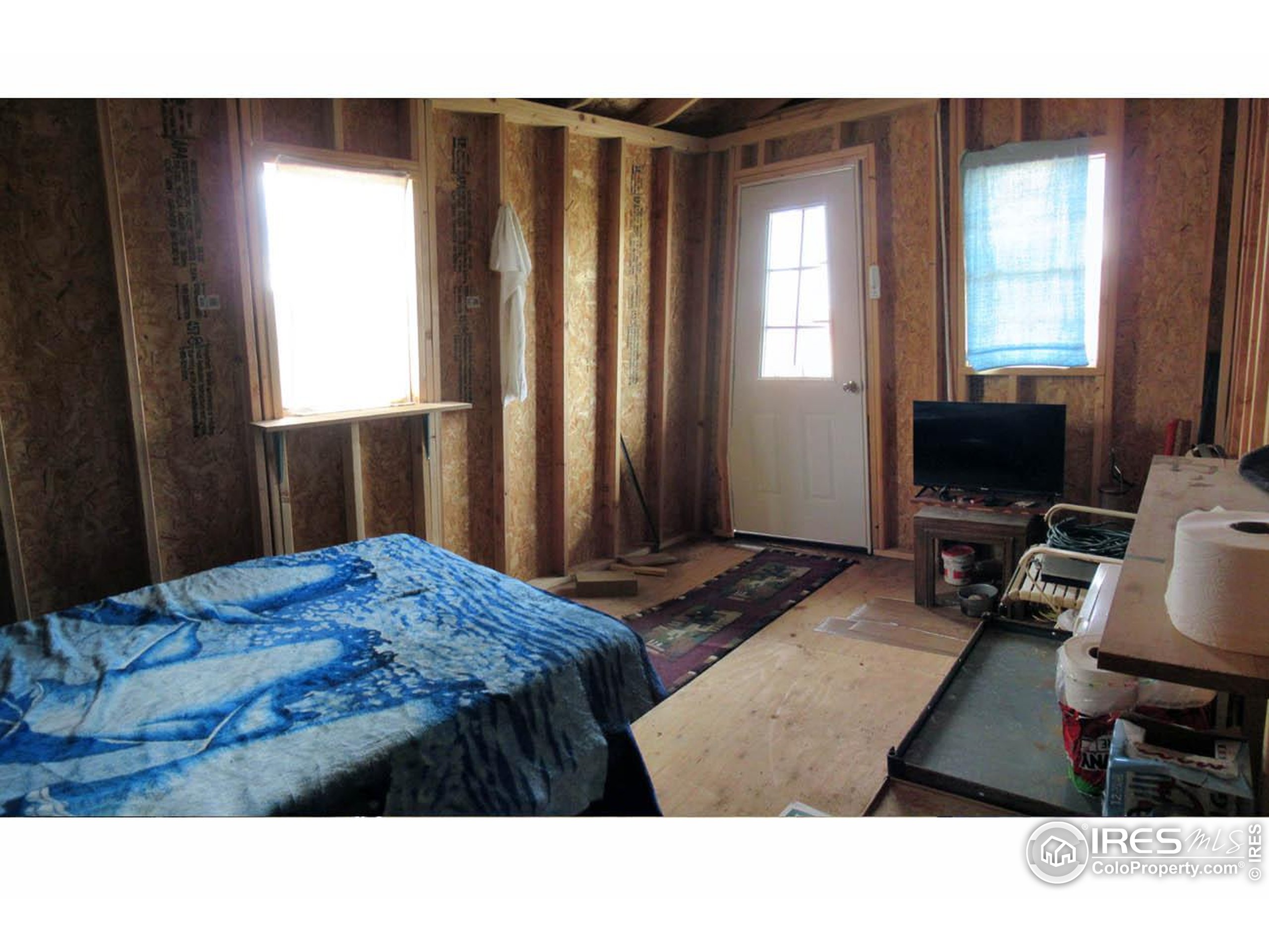 Undisclosed Address Livermore, CO 80536 - Photo 13 of 17 a living room with a bed furniture and a flat screen tv