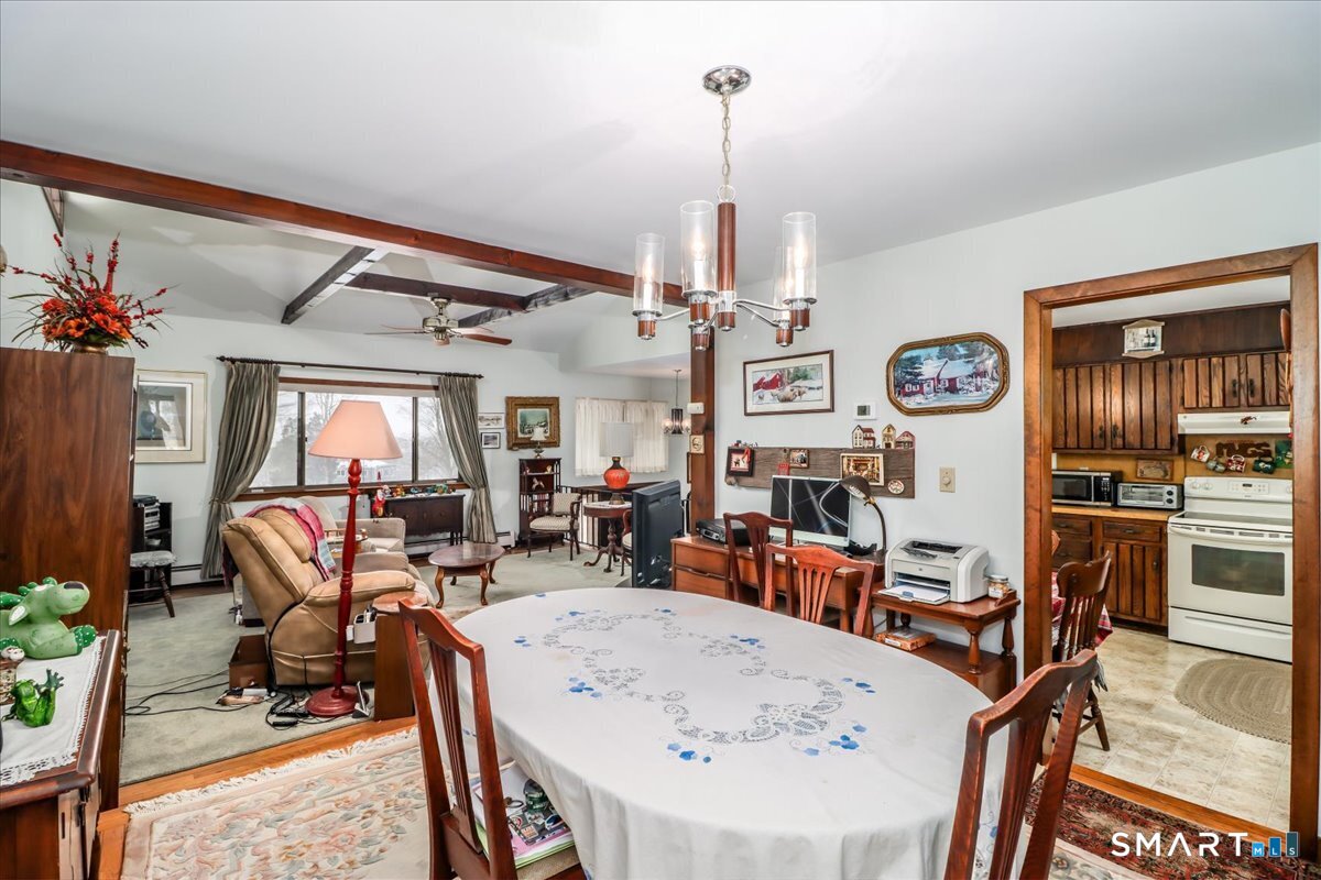 5 Western View Road New Milford, CT 06776 - Photo 12 of 36 a view of a dining room and livingroom with furniture wooden floor a chandelier
