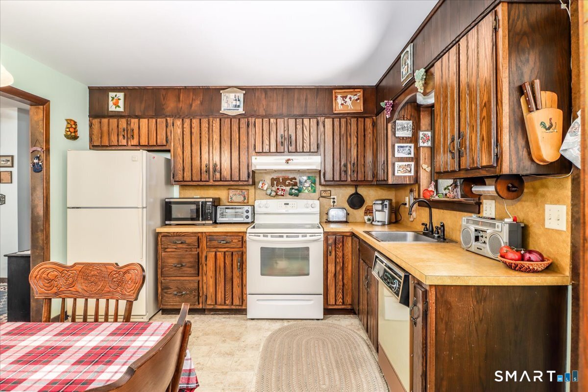 5 Western View Road New Milford, CT 06776 - Photo 14 of 36 a kitchen with a refrigerator a stove a sink dishwasher and wooden cabinets