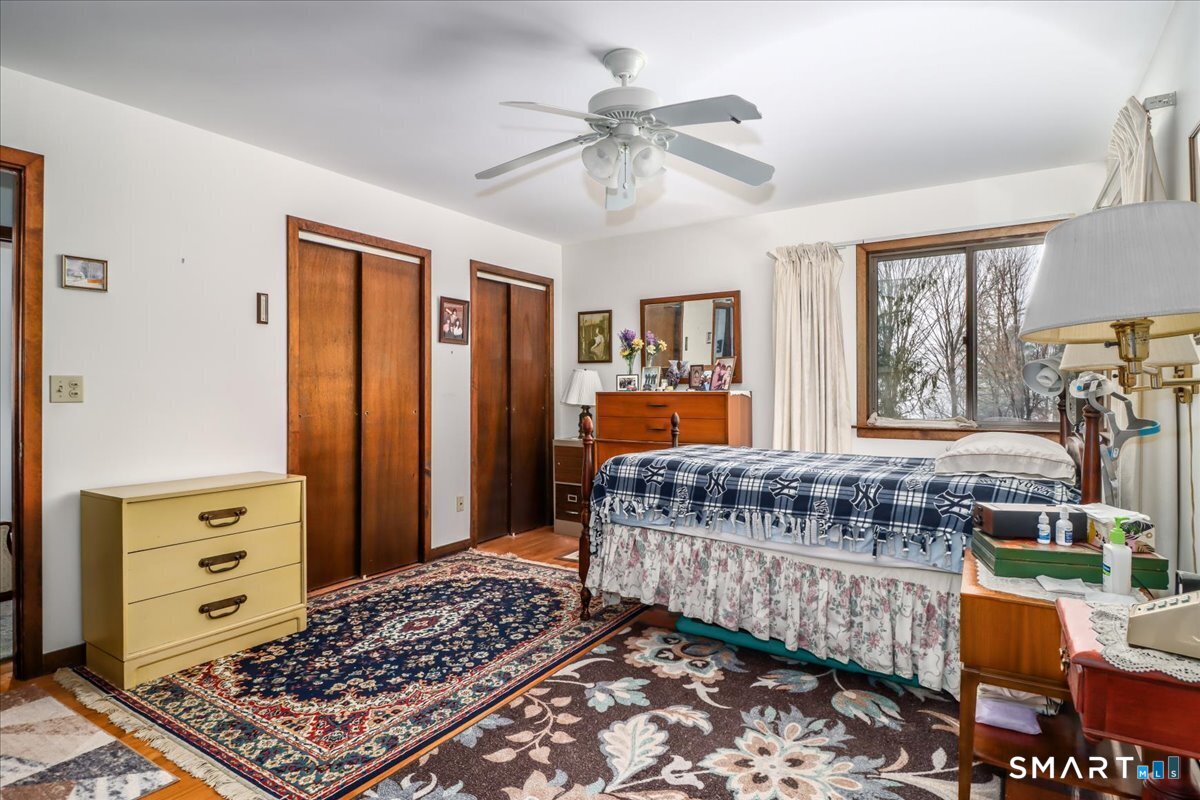 5 Western View Road New Milford, CT 06776 - Photo 17 of 36 a bed room with a bed and a chandelier