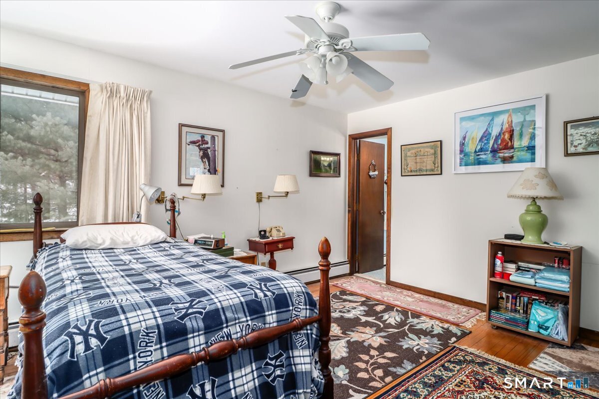 5 Western View Road New Milford, CT 06776 - Photo 18 of 36 a bedroom with a bed and a chandelier