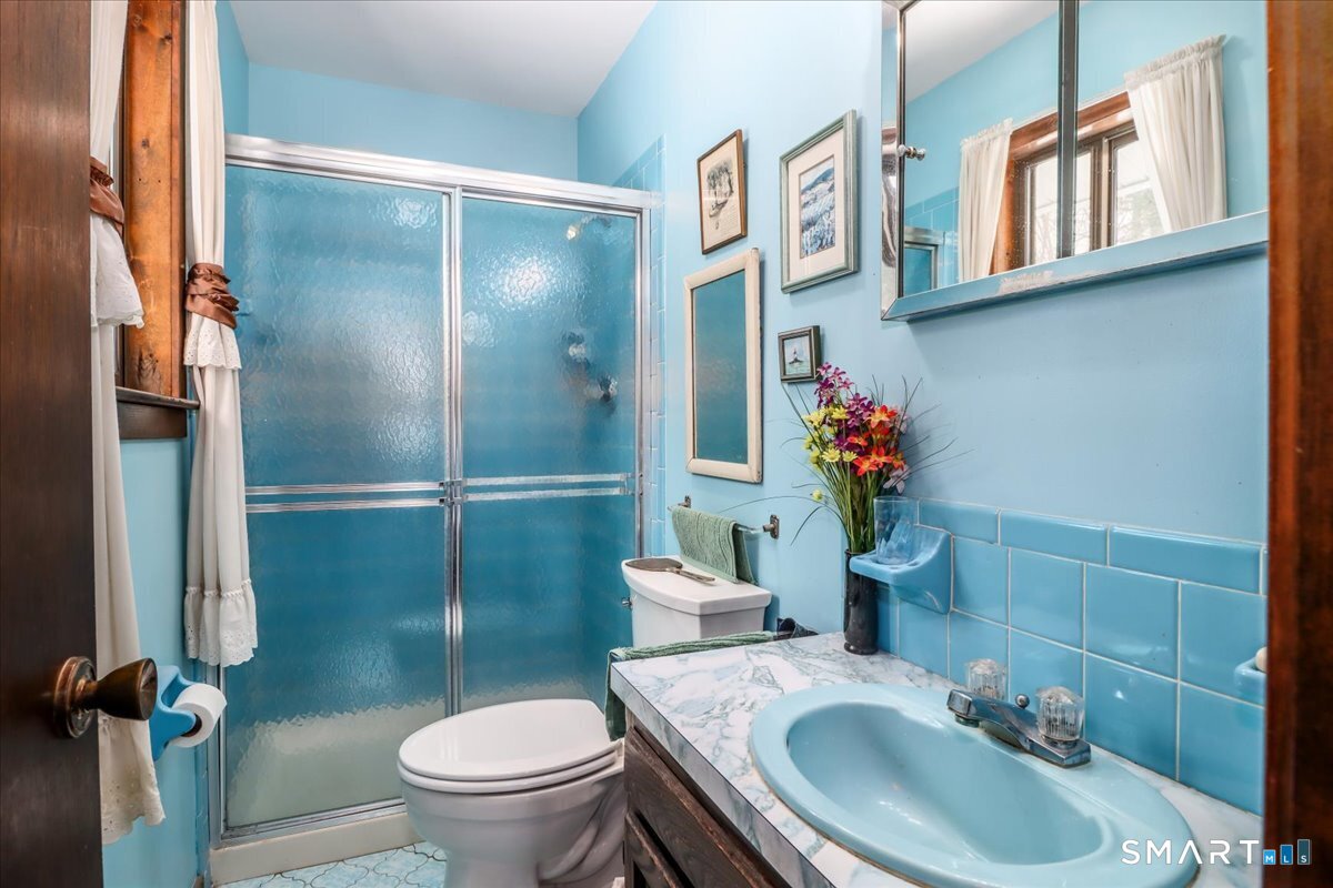 5 Western View Road New Milford, CT 06776 - Photo 19 of 36 a bathroom with a sink toilet and a mirror