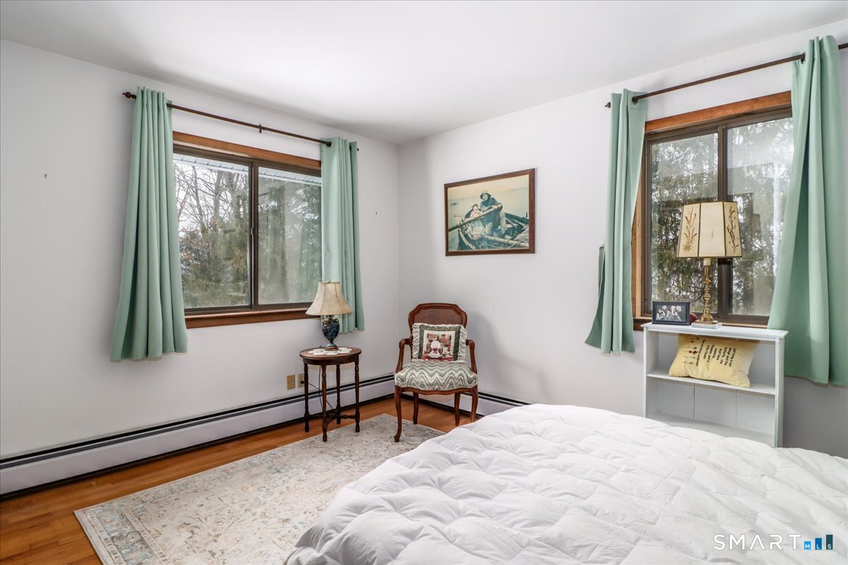 5 Western View Road New Milford, CT 06776 - Photo 20 of 36 a bedroom with a bed and a window with a mirror