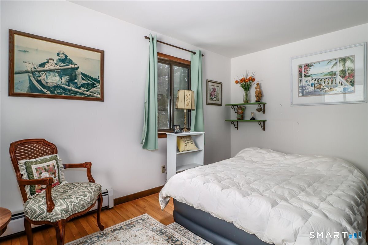 5 Western View Road New Milford, CT 06776 - Photo 21 of 36 a bedroom with a bed and a chair in it