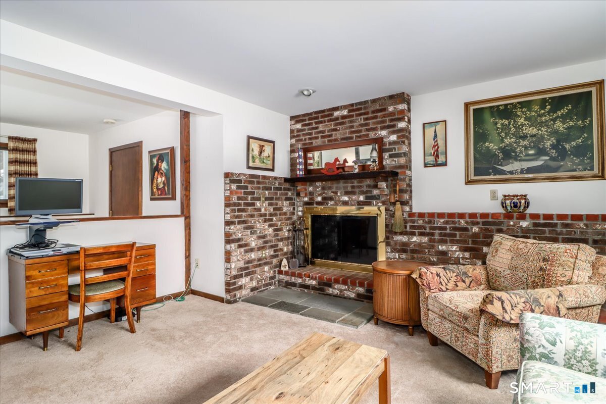 5 Western View Road New Milford, CT 06776 - Photo 29 of 36 a living room with furniture a flat screen tv and a fireplace