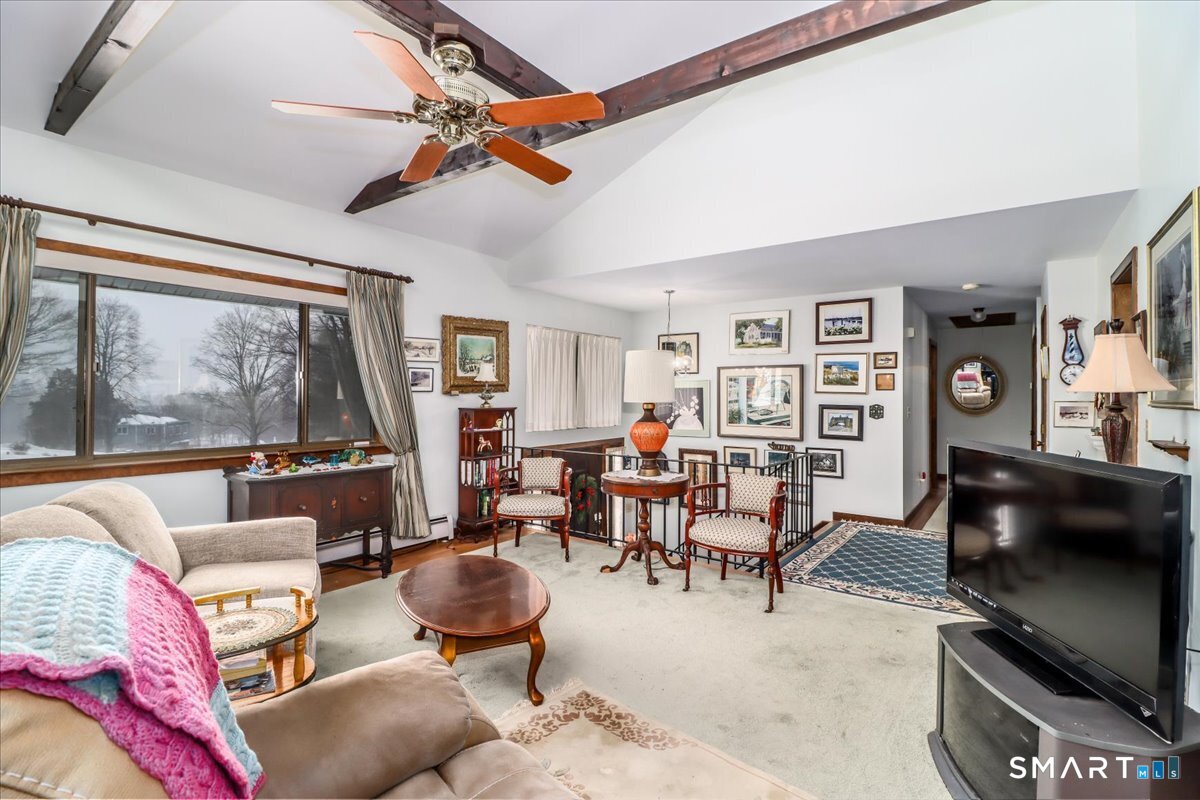 5 Western View Road New Milford, CT 06776 - Photo 8 of 36 a living room with furniture a flat screen tv and a floor to ceiling window