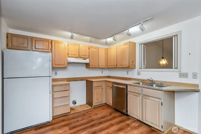 a kitchen with stainless steel appliances white cabinets and a sink