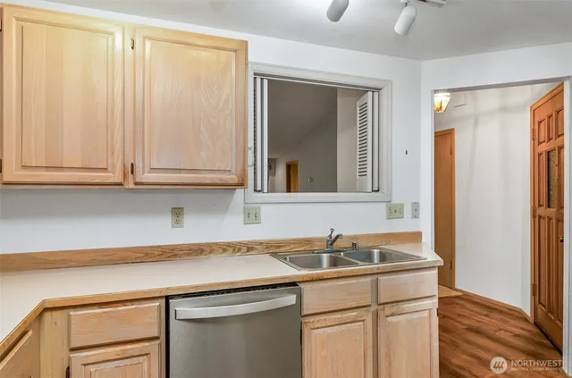 a kitchen with a refrigerator and a sink