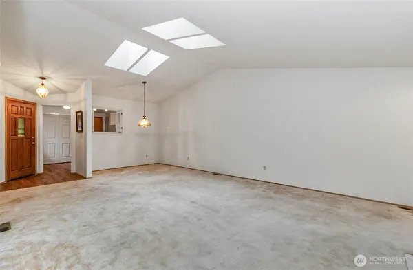 an empty room with entrance and windows