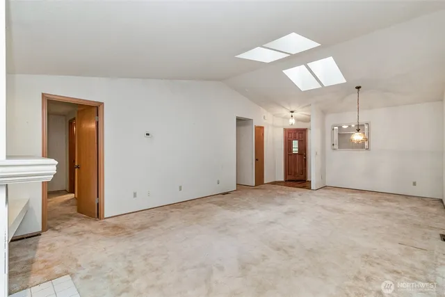 an empty room with furniture and a fireplace